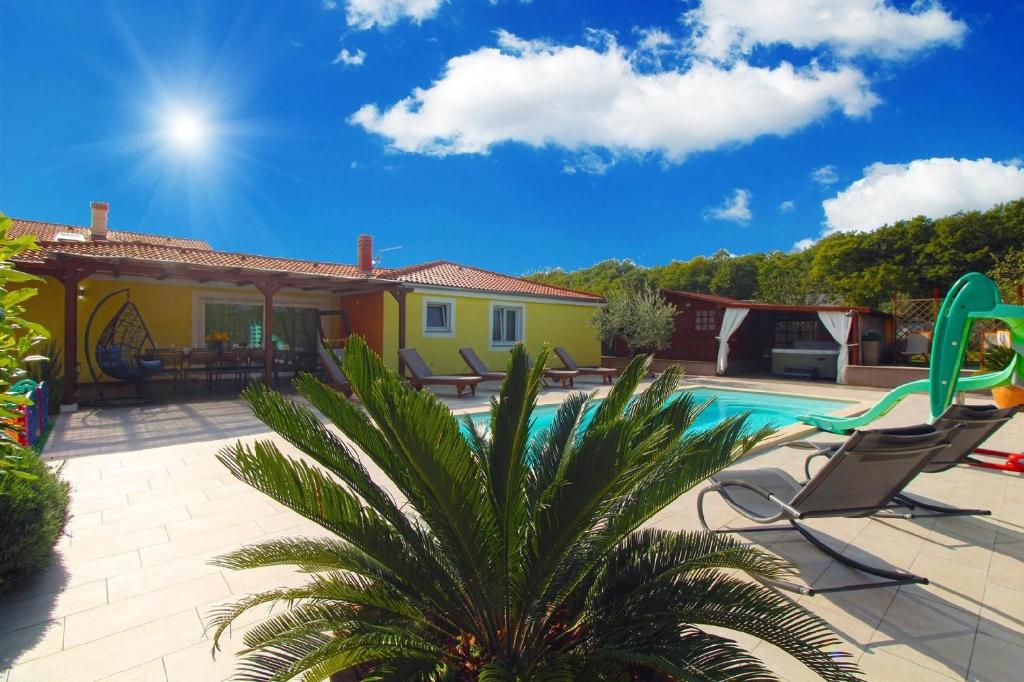 a villa with a swimming pool and a house at Ferienhaus mit Privatpool für 8 Personen ca 130 qm in Loborika, Istrien Südküste von Istrien in Loborika