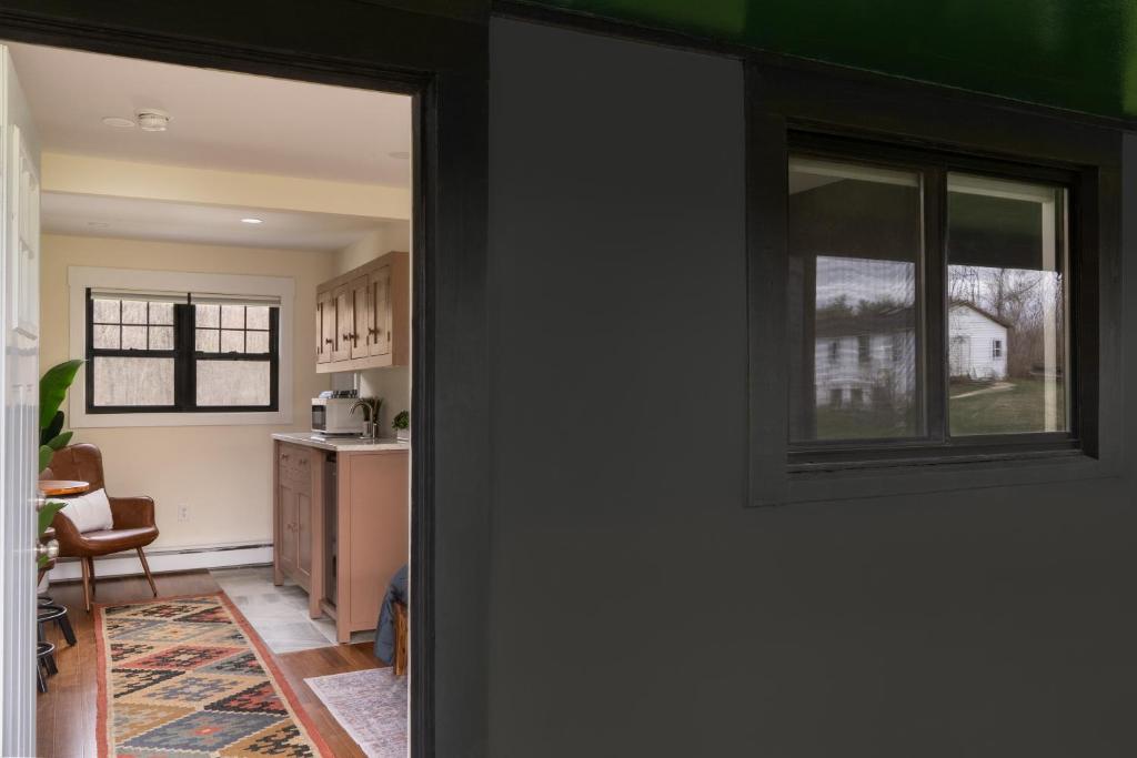 an open door to a kitchen with a window at Willow Pond Motel in Catskill