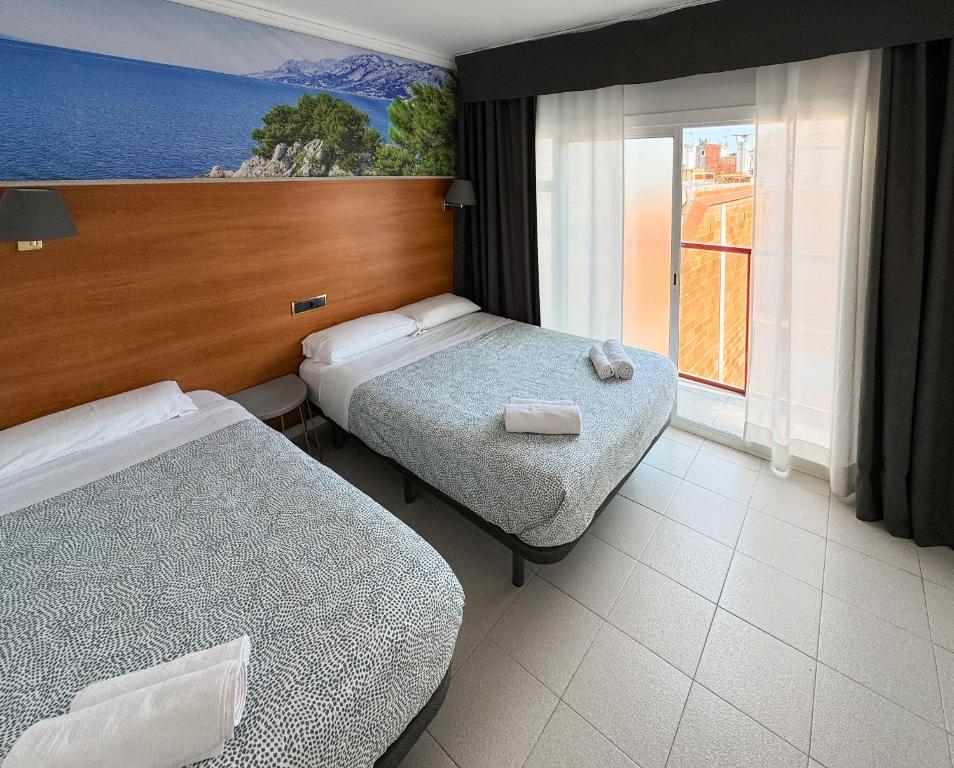Postel nebo postele na pokoji v ubytování Hotel Maremagnum