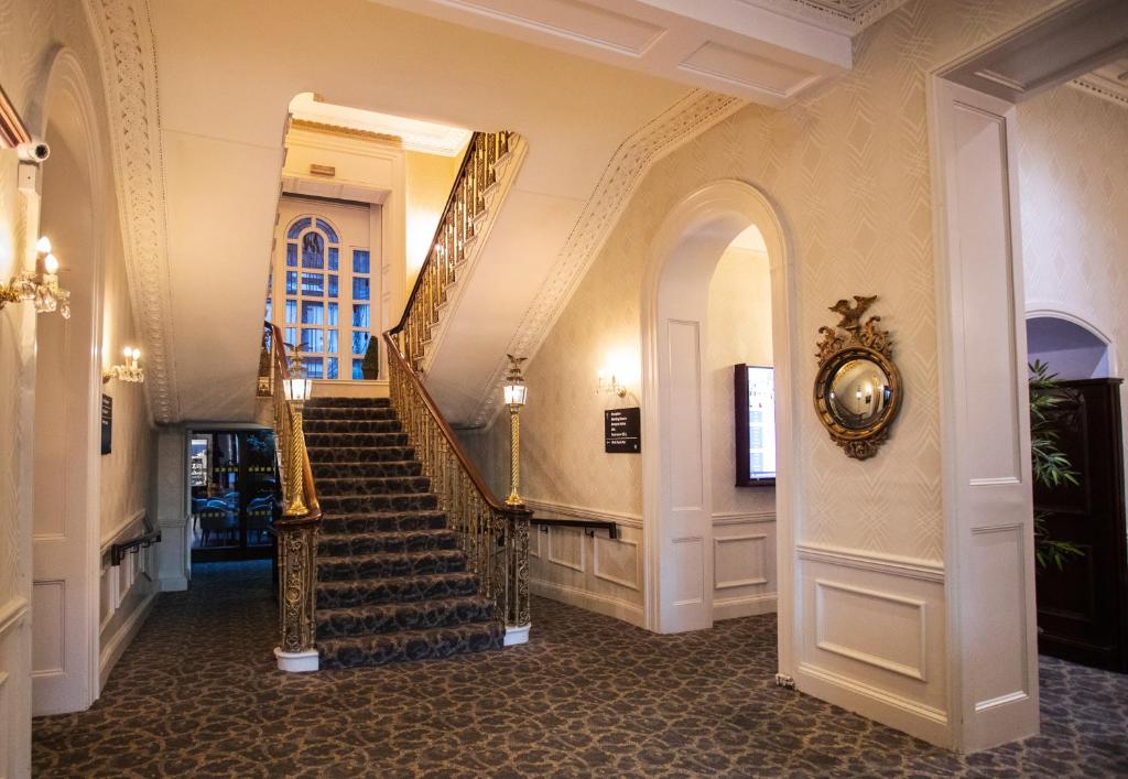 a hallway with a spiral staircase in a building at Grand Hotel in Malahide