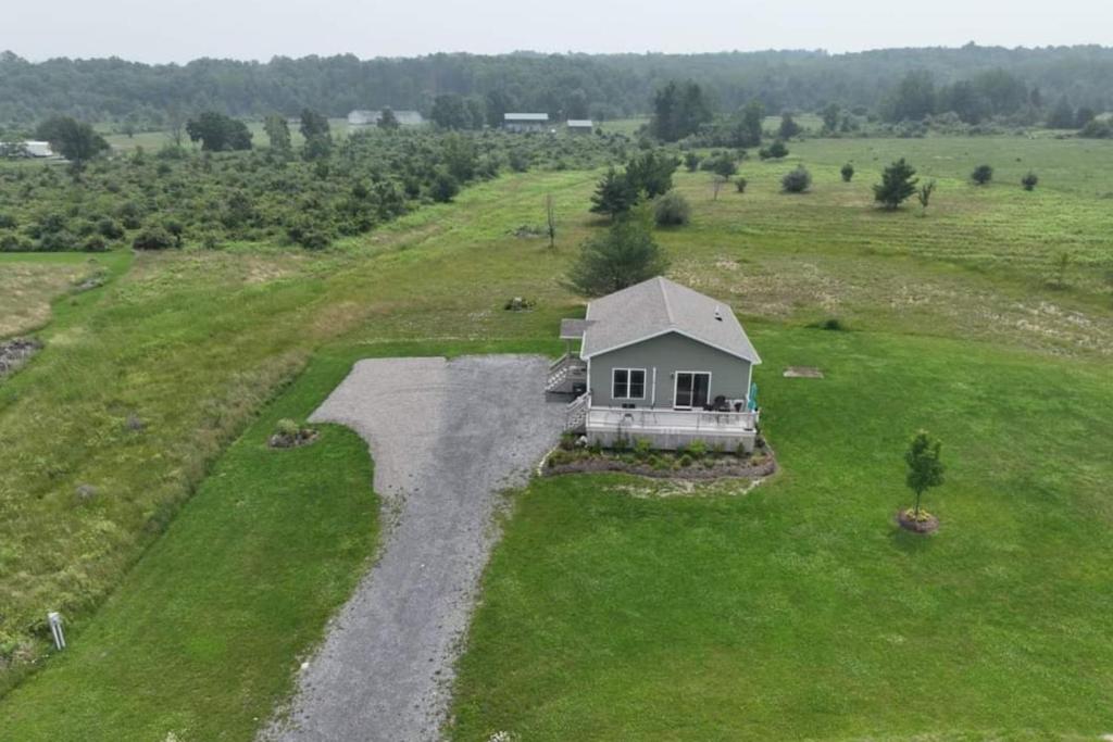 an aerial view of a small house in a field at Ruftop Ridge in Hammondsport