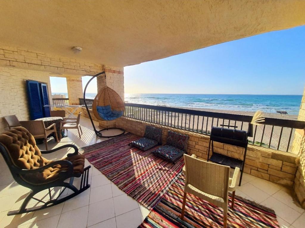 a living room with a view of the ocean at Hotel appartment sea view 3 bedrooms 3 toilets 3rd floor free wifi Bellevue village agami alexandria families are preferred available all year days in Alexandria