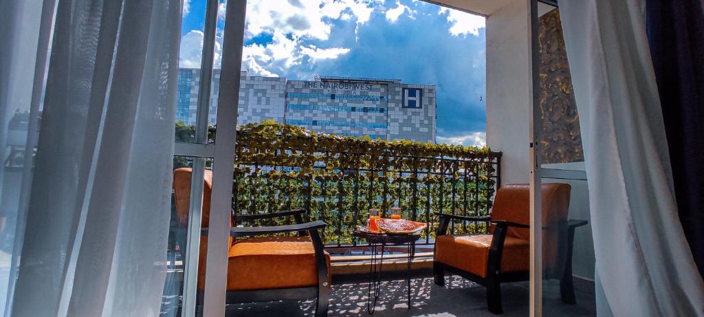 a balcony with chairs and a view of a building at Serene Hills Home in Nairobi