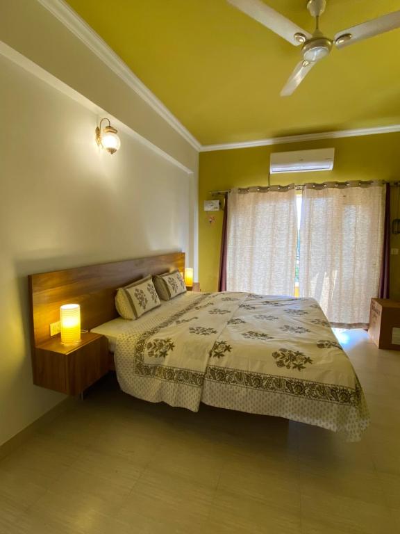 a bedroom with a bed and a ceiling fan at SEPIA STOREYS in Porvorim