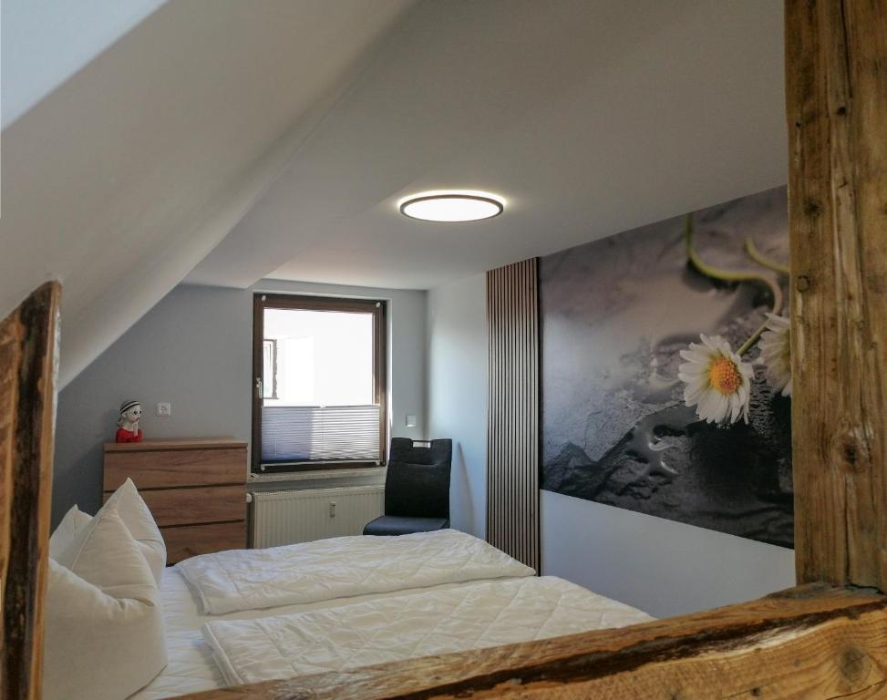 a bedroom with a bed and a painting on the wall at Ferienwohnung Andrea in Hasselfelde