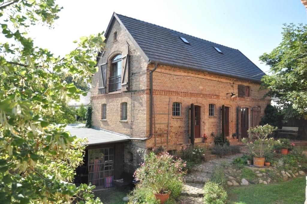 uma antiga casa de tijolos com um telhado preto em Ferienhaus Melzow em Melzow