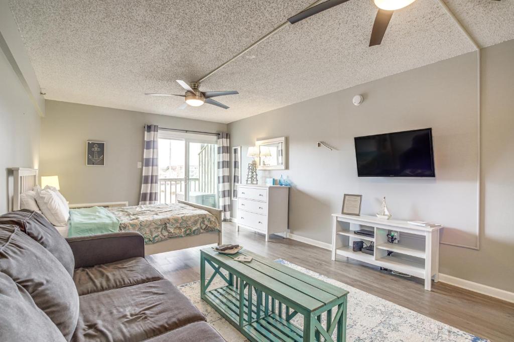 a living room with a couch and a tv at Ocean City Studio - Steps to Boardwalk and Beach! in Ocean City