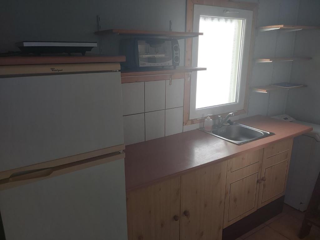 a small kitchen with a sink and a window at Life water small house in Budapest