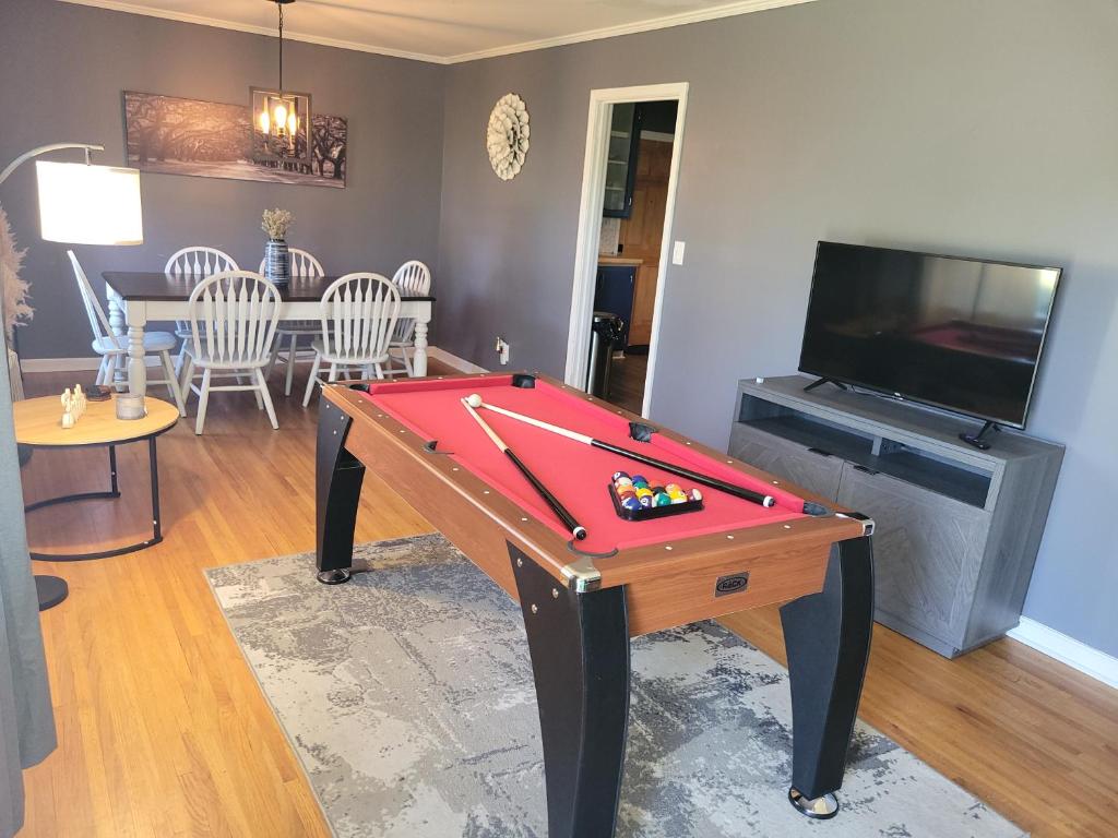 a living room with a pool table and a tv at Capital City Eagle's Nest - Pool Table - Pet Friendly - 6 beds in Montgomery