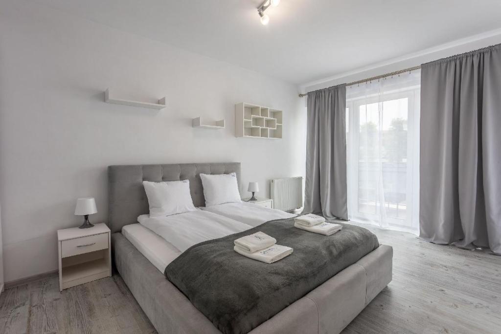 1 dormitorio con 1 cama grande y 2 toallas. en Ferienwohnung am Meer, Urlaub auf der Insel Usedom, Apartment Flotylla 13, en Świnoujście