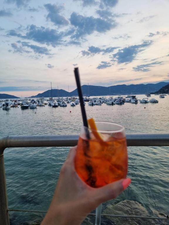 a person holding a drink in front of a marina at Poesia di Lerici in Lerici