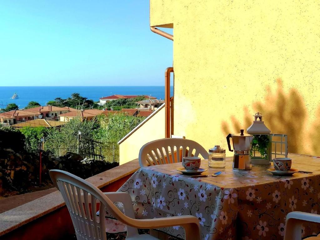d'une table et de chaises sur un balcon avec vue sur l'océan. dans l'établissement Ferienwohnung für 4 Personen ca 60 qm in Lu Bagnu, Sardinien Anglona - b61135, à Castelsardo