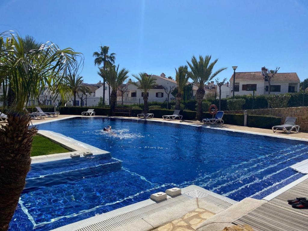 a person swimming in a large swimming pool at Alfaz del Sol in Alfaz del Pi