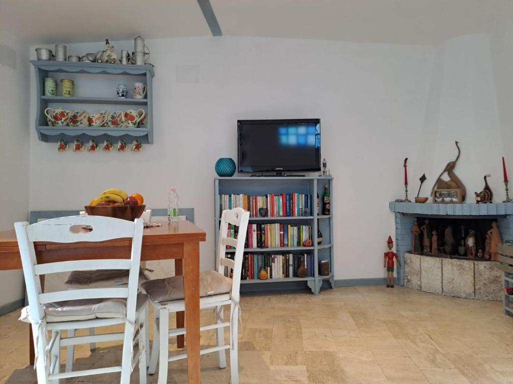 a living room with a table and chairs and a tv at Casa Susy in Rome