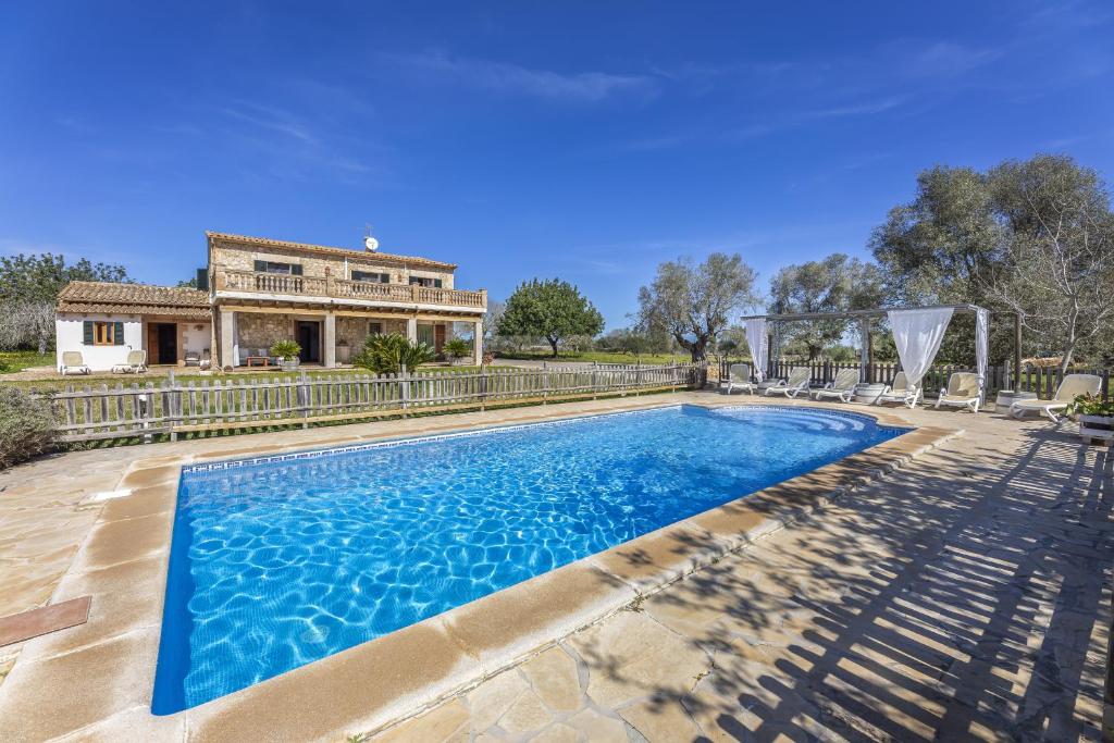 an image of a swimming pool in front of a house at Finca Sa Torreta in Santa Margalida