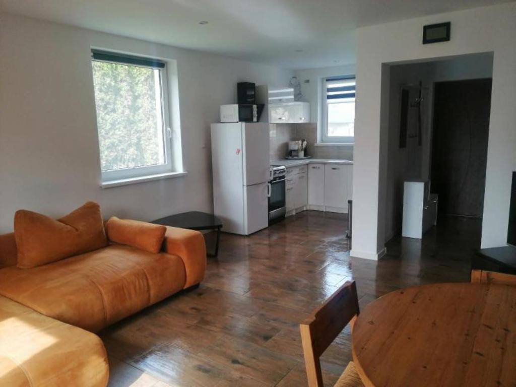 a living room with a couch and a table at Haus Am Meer in Mieroszyno