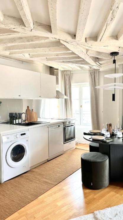 a kitchen with a washer and dryer in a room at Amazing view on the Versailles Palace - Paris 15min in Versailles