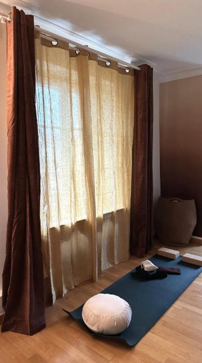 a room with a yoga mat on the floor in front of a window at Amazing view on the Versailles Palace - Paris 15min in Versailles