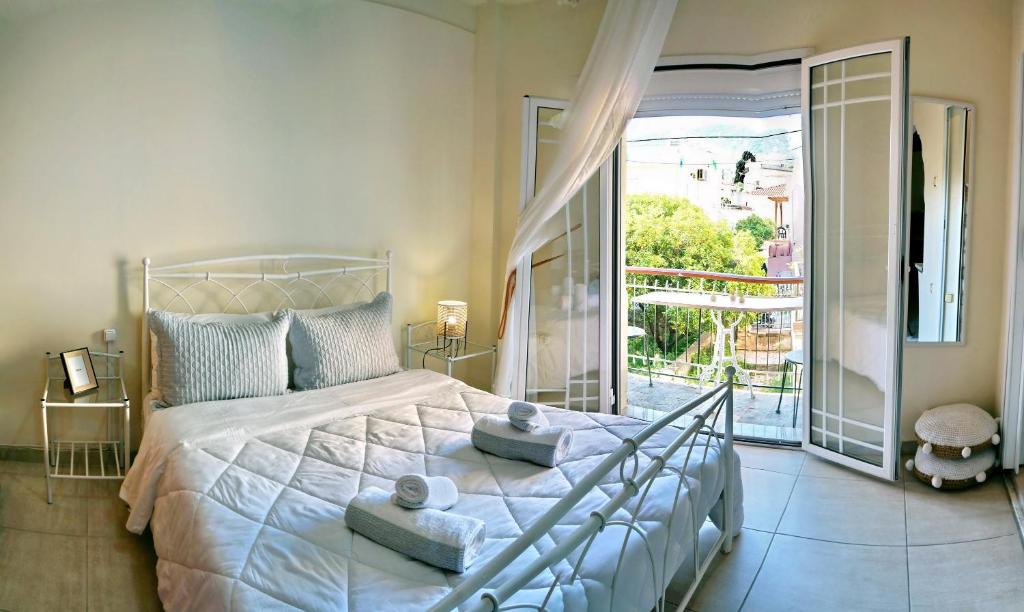 a bedroom with a large bed and a balcony at Spacious Apartment in Mytilene in Mytilini