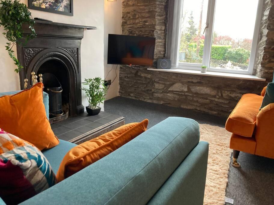 a living room with a couch and a fireplace at Leven's Rest - 2 Bed Maisonette in Backbarrow
