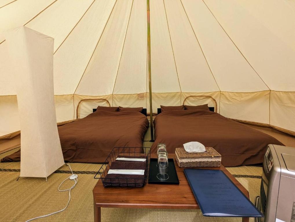 a room with two beds and a table in a tent at Glamchette Okayama -Glamping & Auto Camp- - Vacation STAY 19593v in Mimasaka