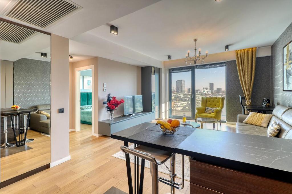 a kitchen and living room with a dining table and a view at Prestige Views: Luxury Retreat in Bucharest