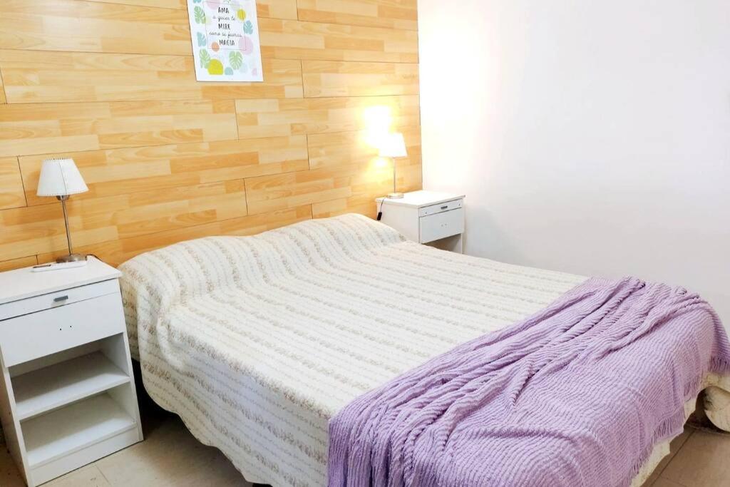 a small bedroom with a bed and two night stands at Villawolf Casa para 5 personas in Federación