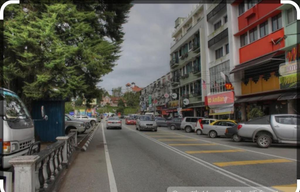 a city street with cars parked on the side of the road at Hillside cottage tanah rata in Tanah Rata