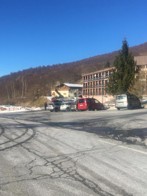 a parking lot with cars parked in front of a building at Garessio 2000 primo residence Montagna e Mare in Garessio