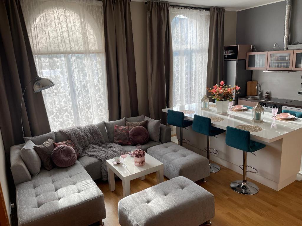a living room with a couch and a table at Kunderi apartment with sauna in Rakvere