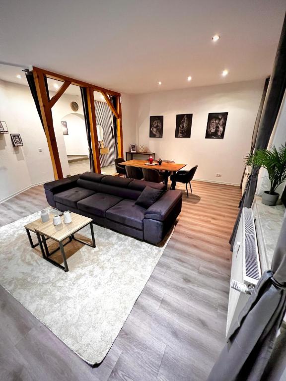 a living room with a couch and a table at Modern City Suites in Oberhausen