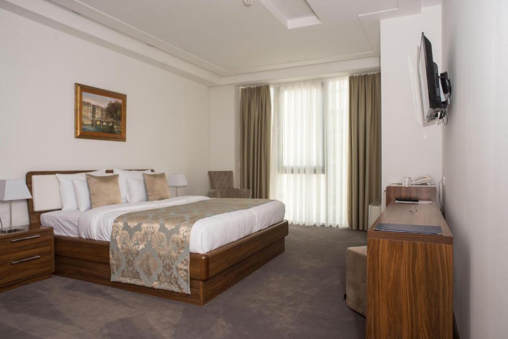 Postel nebo postele na pokoji v ubytování Hotel Royal Gold City