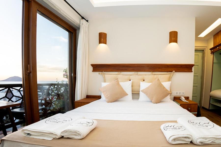 a bedroom with a bed with two towels on it at west coast boutique hotel in Bodrum City