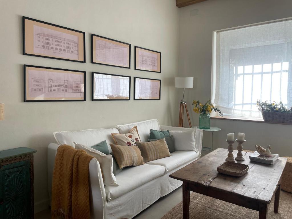 een woonkamer met een witte bank en een tafel bij Apartamento en Alameda Sundheim in Huelva