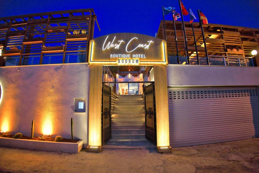 a front door of a building with a sign on it at west coast boutique hotel in Bodrum City