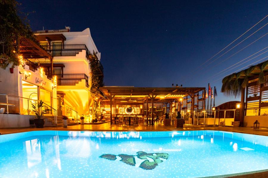 a large swimming pool in front of a building at west coast boutique hotel in Bodrum City