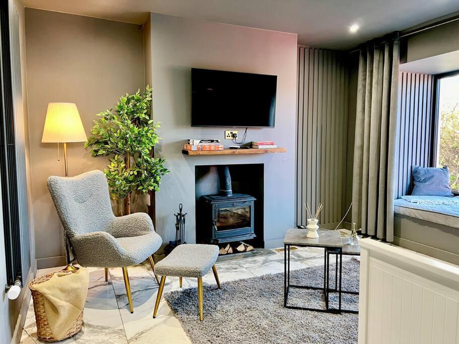 a living room with a fireplace and a tv at Luxury Redcar Seaside Retreat in Redcar