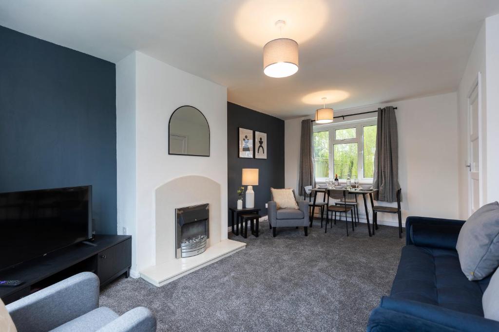 a living room with a couch and a fire place at Jameson Lodge in Hartlepool