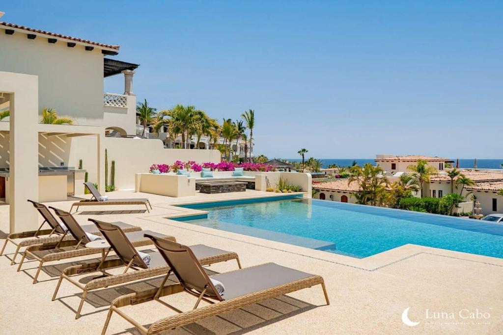 a villa with a swimming pool and lounge chairs at Luxe Oceanview Villa with Pool Hot Tub BBQ and Fire Pit in San José del Cabo