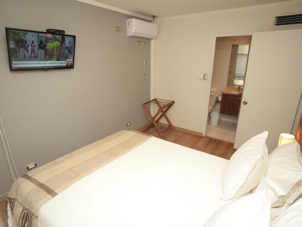 Postel nebo postele na pokoji v ubytování De Triana Hotel