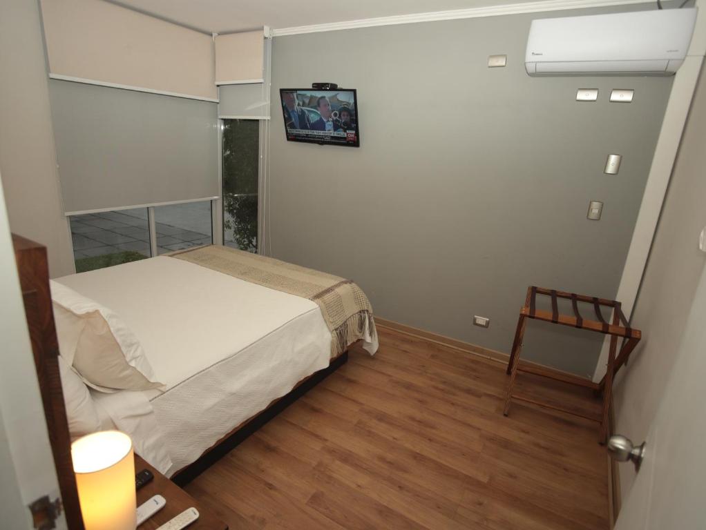 Postel nebo postele na pokoji v ubytování De Triana Hotel
