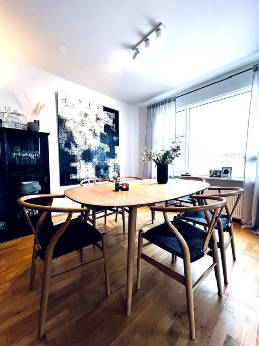 a dining room with a table and chairs at Lovely 2 bedroom apartment with a large own patio in Garðabær
