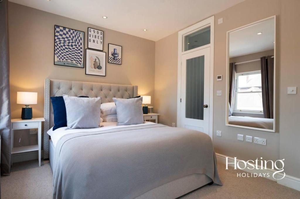 a bedroom with a large bed and a mirror at Marlow's Hidden Gem in Marlow