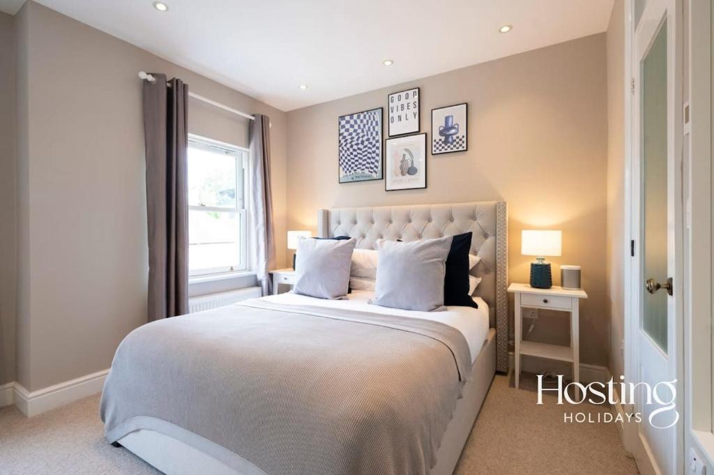 a bedroom with a large white bed with a window at Station House in Marlow