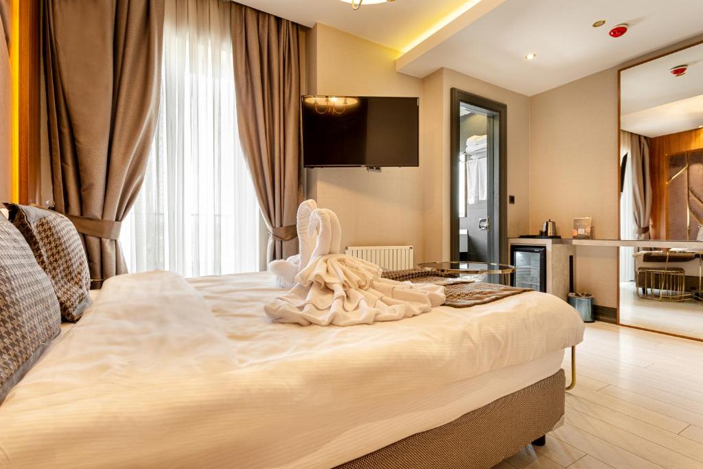Postel nebo postele na pokoji v ubytování Santra Hotel