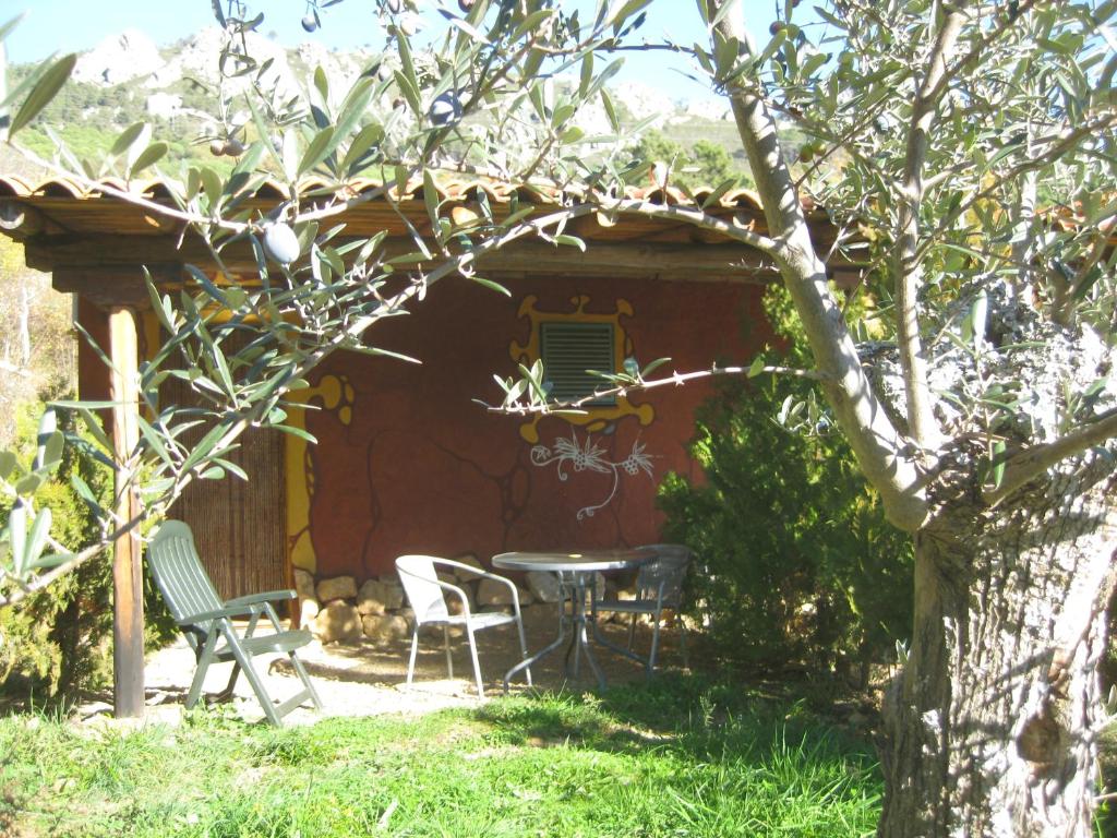 a patio with a table and chairs in front of a house at Apartamentos Rurales Candela in Cañamero