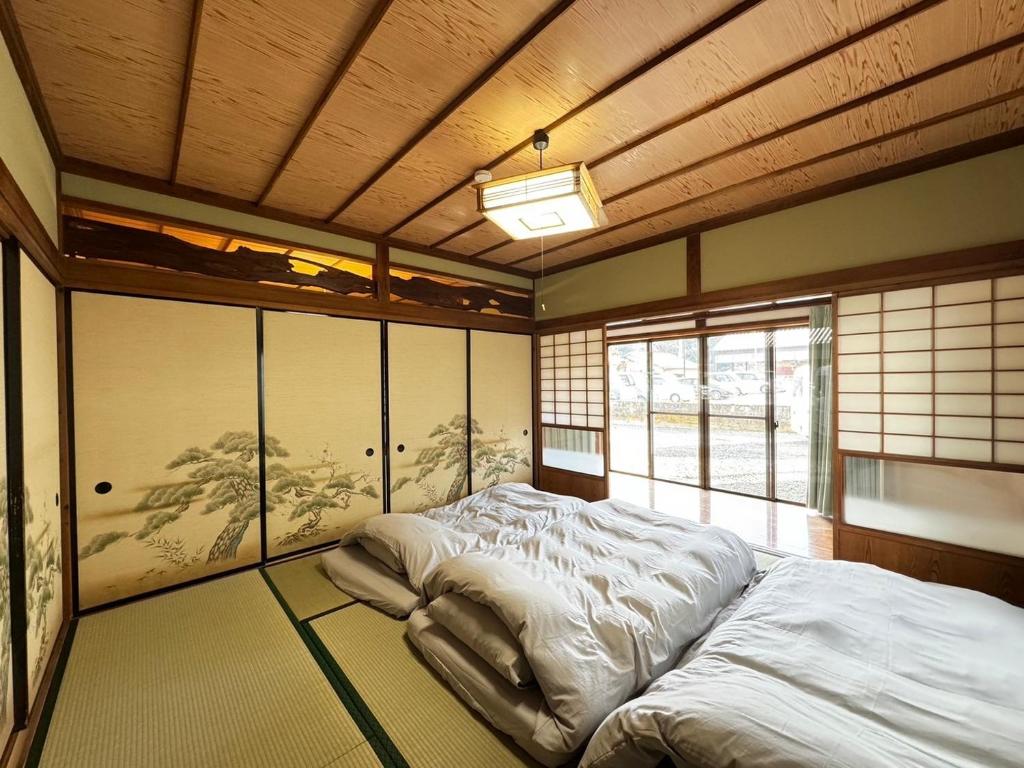 a large bed in a room with a wooden ceiling at Polar Resort Nikko 4 - Vacation STAY 30491v in Nikko