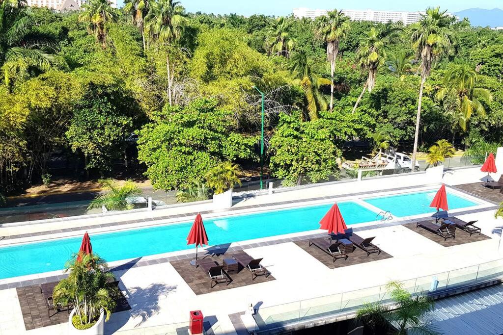 an image of a swimming pool with umbrellas at Nuevo Vallarta Condo 2Bed 2Bath in Nuevo Vallarta 