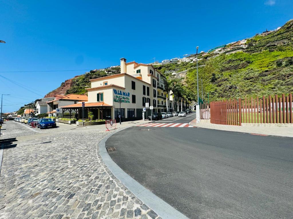 an empty street with a building on the side of a hill at VALE MAR Guest in Ribeira Brava