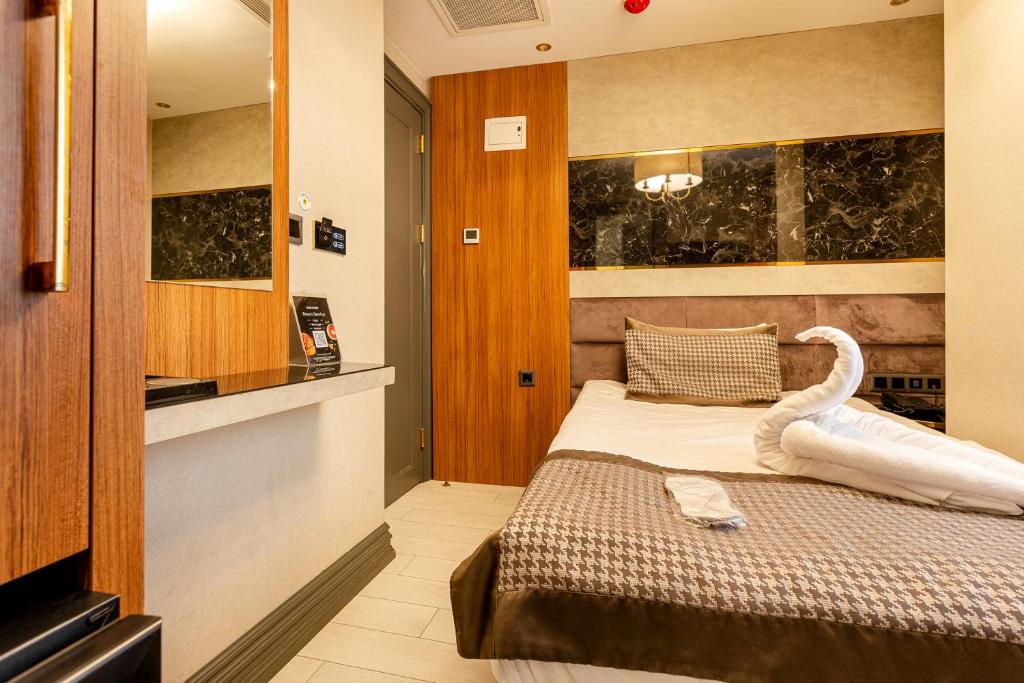 Postel nebo postele na pokoji v ubytování Santra Hotel